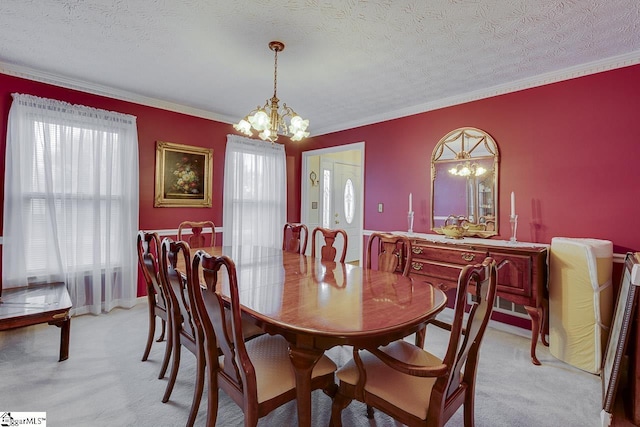 carpeted dining room featuring a wealth of natural light, a chandelier, and a textured ceiling