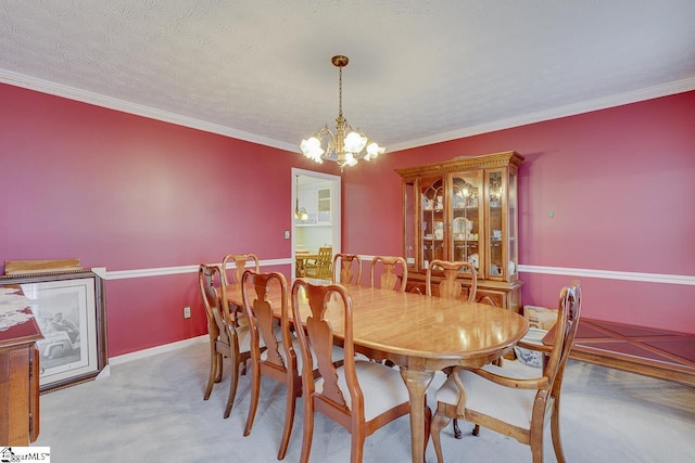 dining space with ornamental molding, light carpet, a textured ceiling, and a chandelier