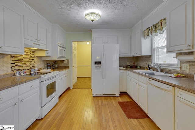 kitchen featuring white cabinetry, sink, light hardwood / wood-style floors, crown molding, and white appliances