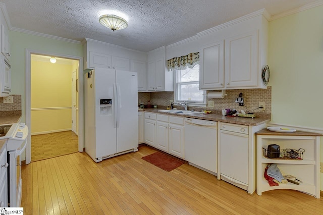 kitchen featuring sink, white appliances, light hardwood / wood-style flooring, and white cabinets