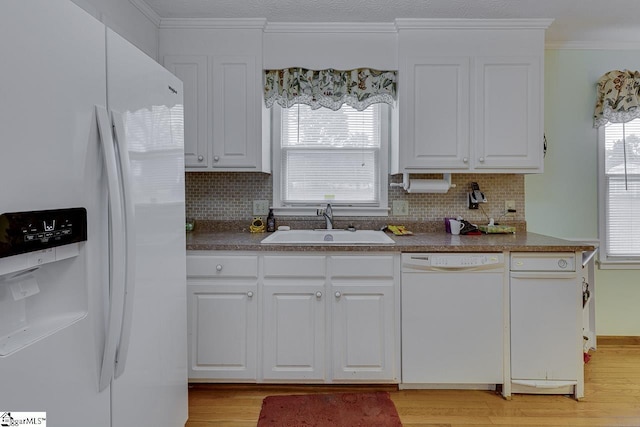 kitchen with white cabinetry, sink, white appliances, and backsplash