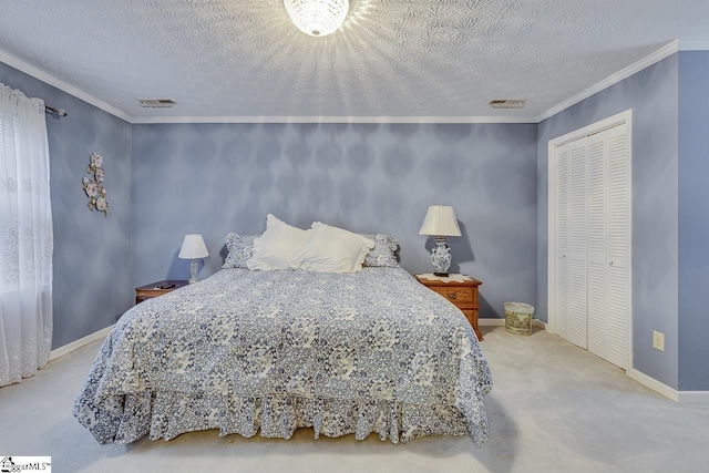 bedroom with crown molding, a closet, a textured ceiling, and carpet