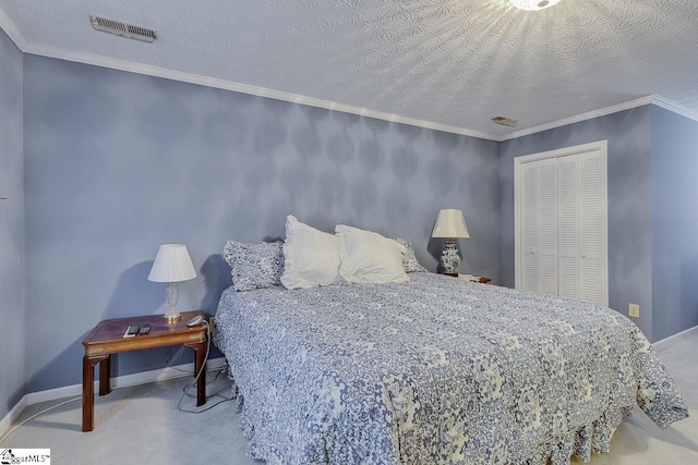 carpeted bedroom featuring ornamental molding, a closet, and a textured ceiling