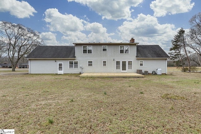 back of property featuring a wooden deck, a yard, and central AC unit