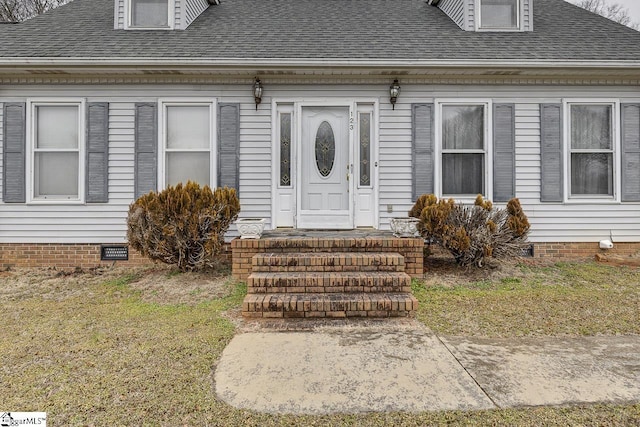 doorway to property featuring a yard