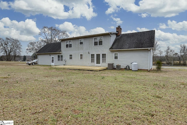 rear view of house featuring a yard, central AC, and a deck