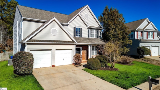 front of property with a garage, central AC unit, and a front yard