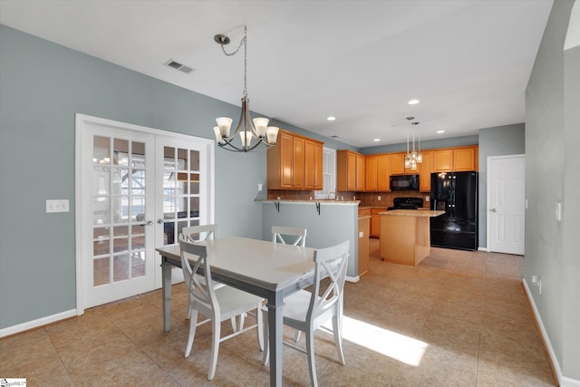 dining space featuring a notable chandelier and french doors