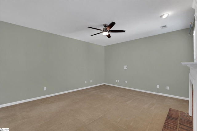 unfurnished living room featuring light colored carpet, a fireplace, and ceiling fan