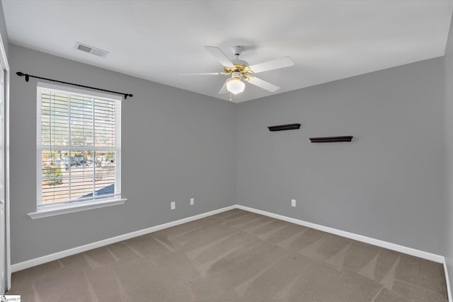 unfurnished room with ceiling fan and carpet