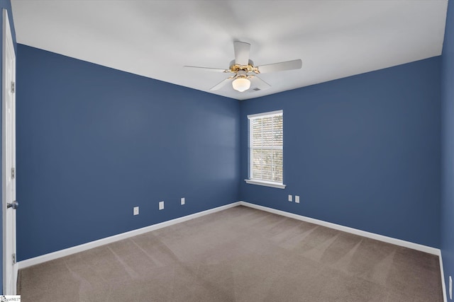 carpeted spare room with ceiling fan