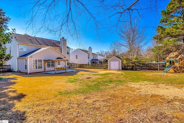 view of yard with a shed, a patio, and a playground