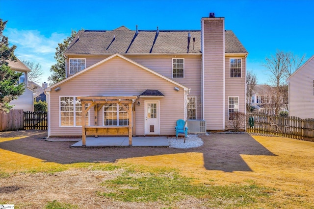 back of property with cooling unit, a patio area, and a lawn