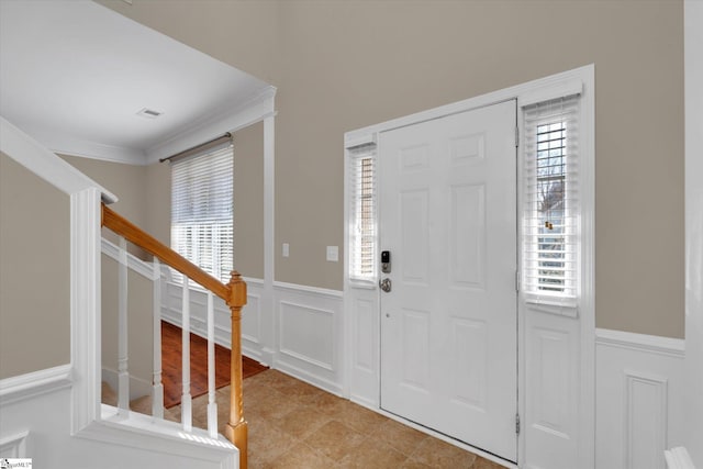 tiled entrance foyer with crown molding