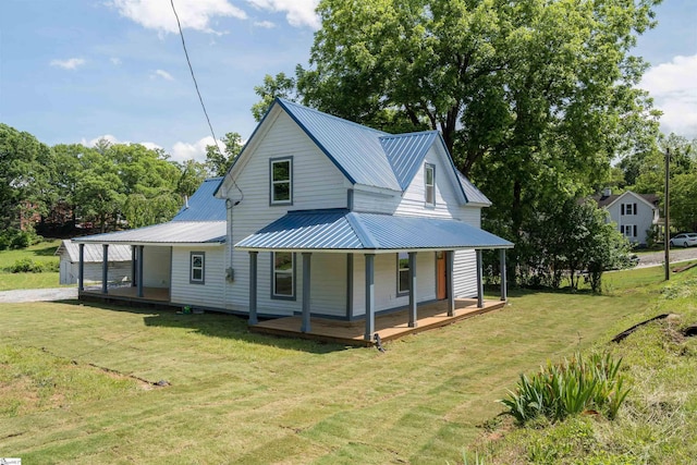 back of property with covered porch and a lawn