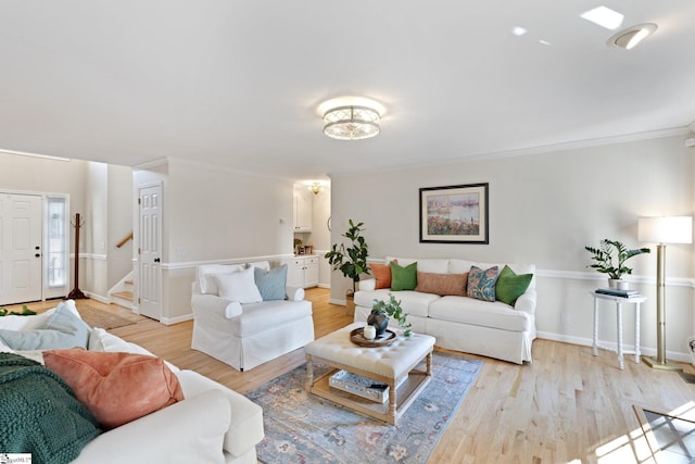 living room featuring crown molding and light hardwood / wood-style flooring