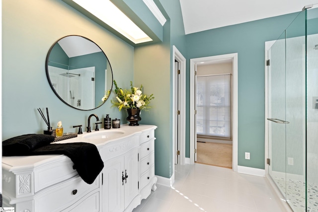 bathroom with vanity, a shower with shower door, and tile patterned floors