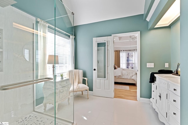 bathroom with vanity, a shower with shower door, and vaulted ceiling