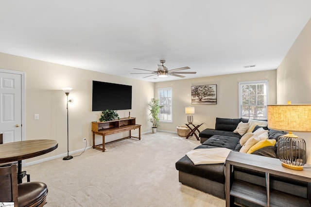 carpeted living room featuring ceiling fan