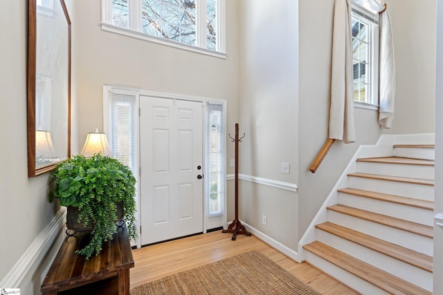 entrance foyer with plenty of natural light and light hardwood / wood-style floors