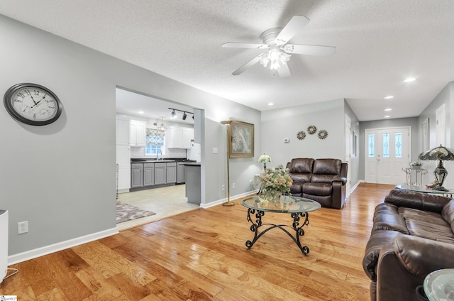 234 Riverrun Dr, Spartanburg, SC 29302 - living room with ceiling fan, light hardwood / wood-style floors, sink, and a textured ceiling
