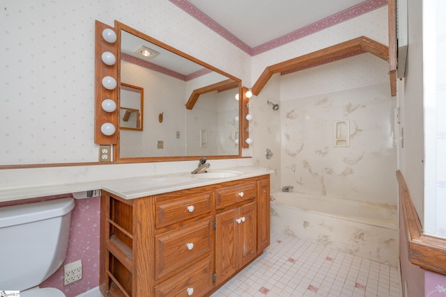 bathroom with a washtub, vanity, tile patterned floors, and toilet