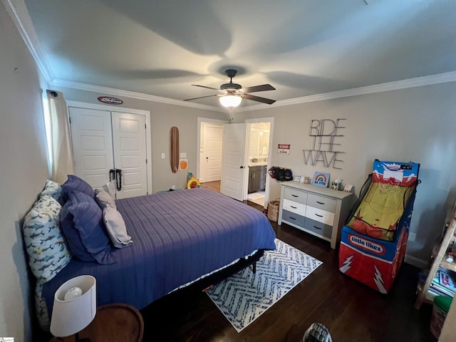 bedroom featuring crown molding, ceiling fan, dark hardwood / wood-style floors, ensuite bathroom, and a closet