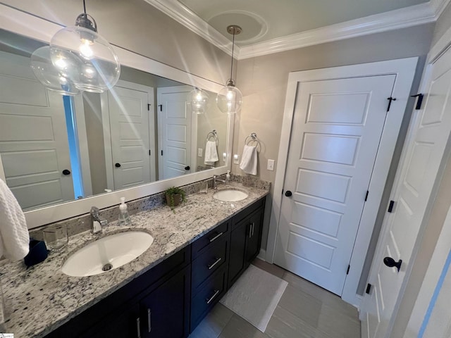 bathroom featuring tile patterned flooring, crown molding, and vanity