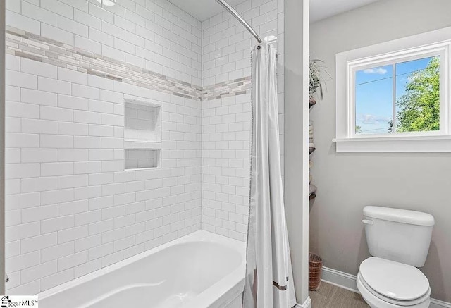 bathroom featuring shower / bath combo and toilet