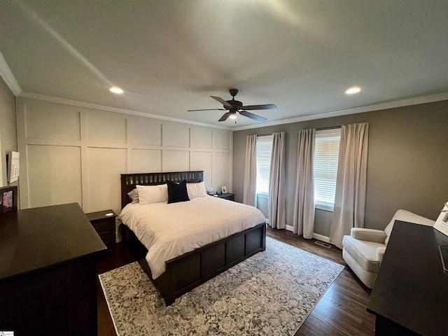 bedroom with ornamental molding, dark hardwood / wood-style floors, and ceiling fan