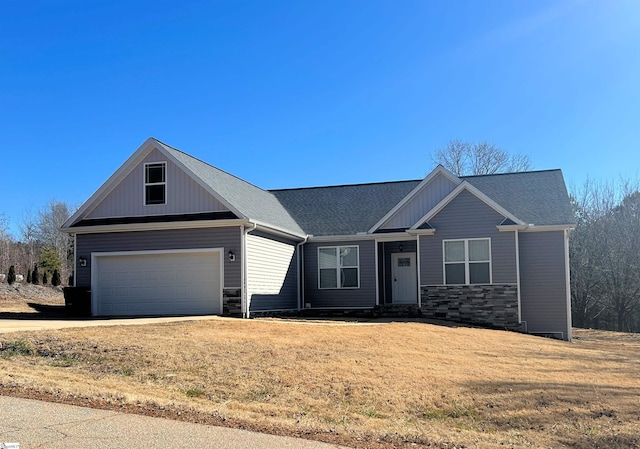 view of front of house with a garage and a front lawn