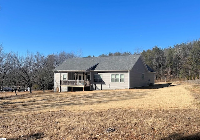 rear view of house featuring a lawn