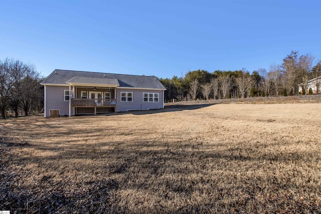 back of house with a yard and ceiling fan