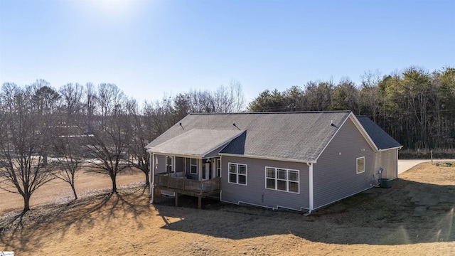 back of property with a porch and central AC