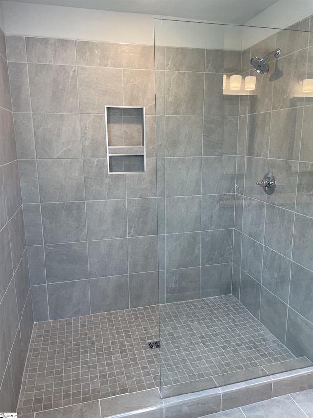 bathroom with tiled shower