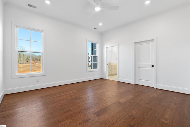 empty room with crown molding, ceiling fan, a healthy amount of sunlight, and dark hardwood / wood-style flooring