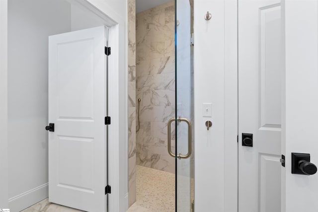 bathroom with a shower with shower door