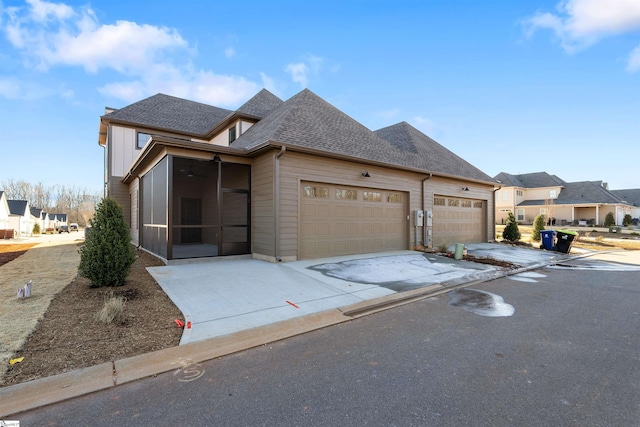 view of front of property with a garage and a sunroom