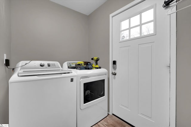 laundry room featuring washer and dryer and light wood-type flooring