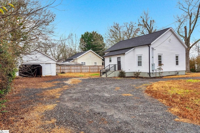 view of property exterior with an outbuilding