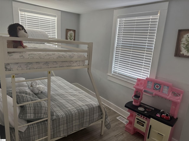 bedroom featuring hardwood / wood-style flooring and multiple windows