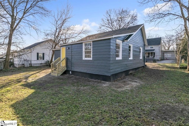 view of side of home featuring a yard