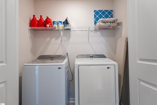 clothes washing area with independent washer and dryer