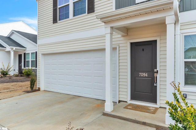 doorway to property with a garage