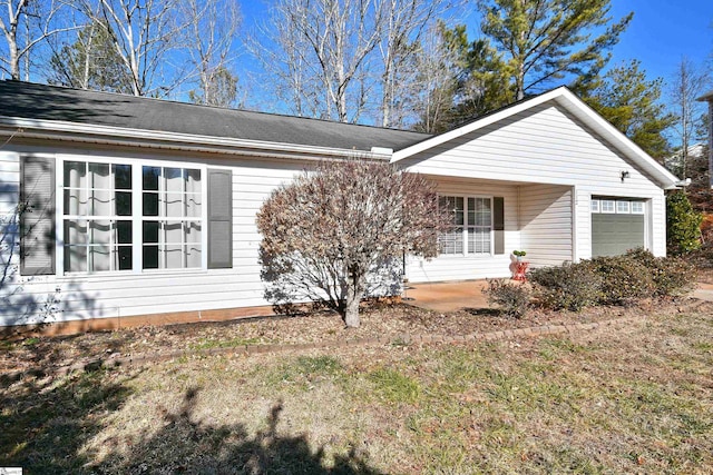 exterior space with a garage and a front yard