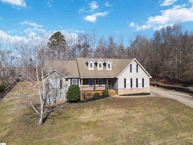 cape cod house with covered porch and a front yard