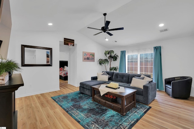 living room featuring vaulted ceiling, ceiling fan, and light hardwood / wood-style flooring