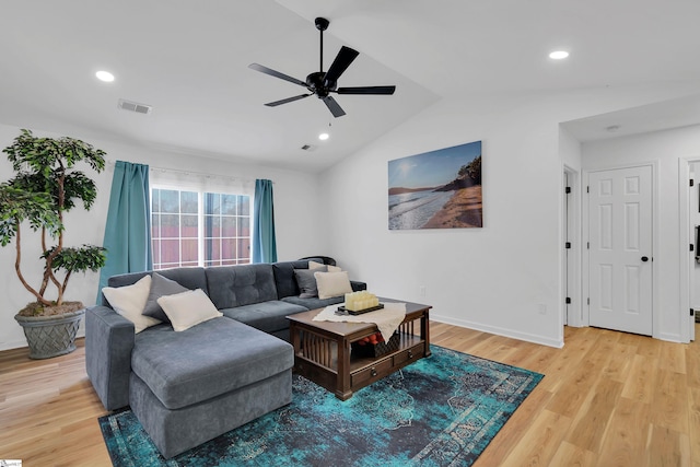 living room featuring lofted ceiling, ceiling fan, and light hardwood / wood-style flooring