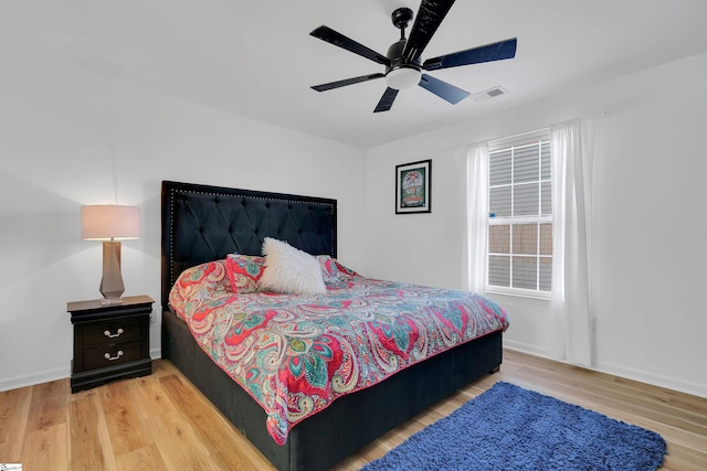 bedroom with light hardwood / wood-style floors and ceiling fan