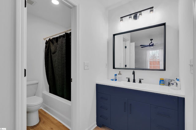 full bathroom featuring vanity, hardwood / wood-style flooring, toilet, and shower / tub combo with curtain